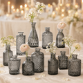 Set of 12 black glass bud vases with white and blush flowers on an elegant wedding table