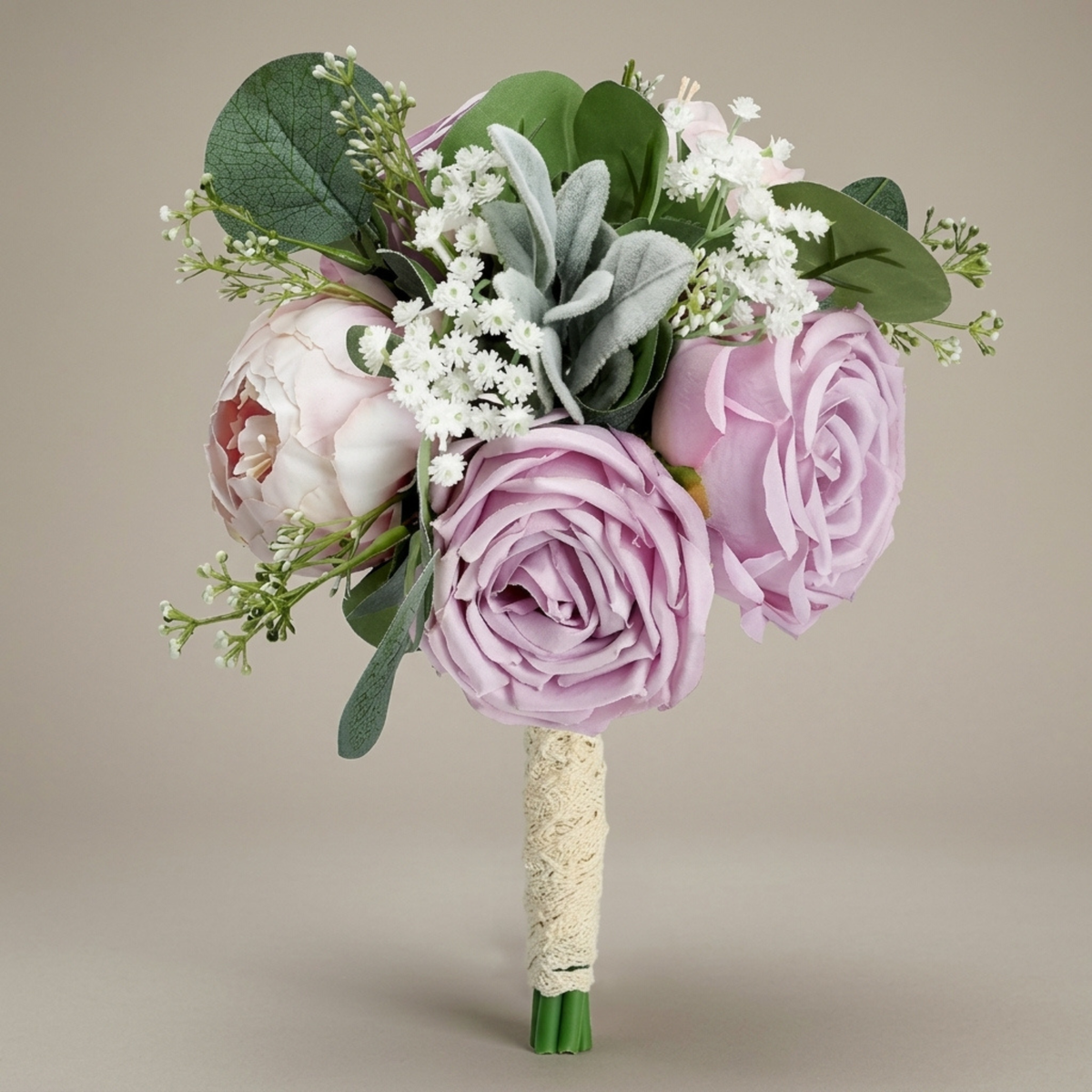 Purple and lilac peony bridesmaid bouquet with baby's breath and lamb's ear greenery on a neutral background