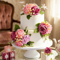 Pink mauve silk rose cake topper on two tier wedding cake with artificial flowers and greenery