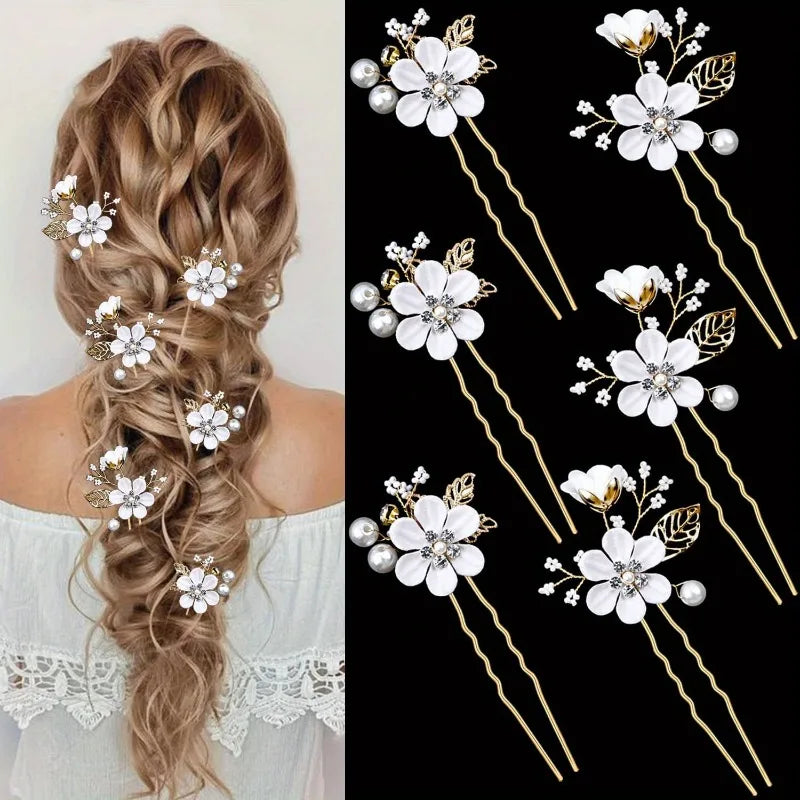 Loose curly bridal hair from behind with white flower hair pins placed down the length, next to the 6-pin set