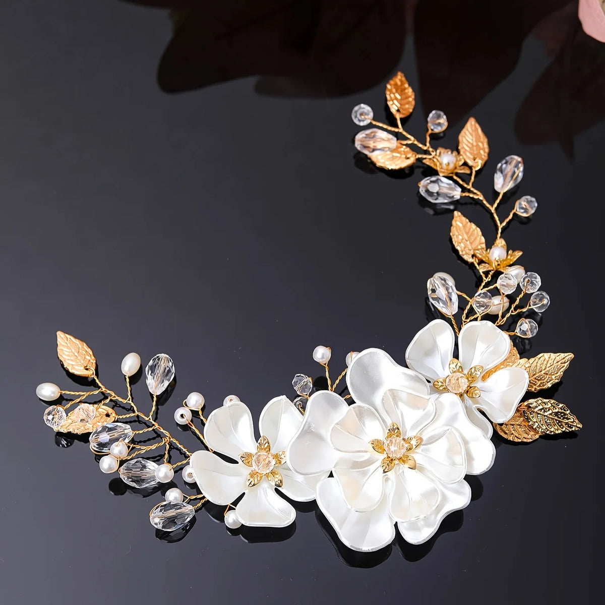 Gold leaf hair vine with three white flowers, pearls and crystal drops curved in a crescent