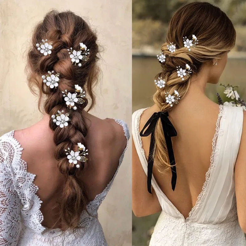 Two brides with long braids decorated with white flower and pearl hair pins in lace dresses