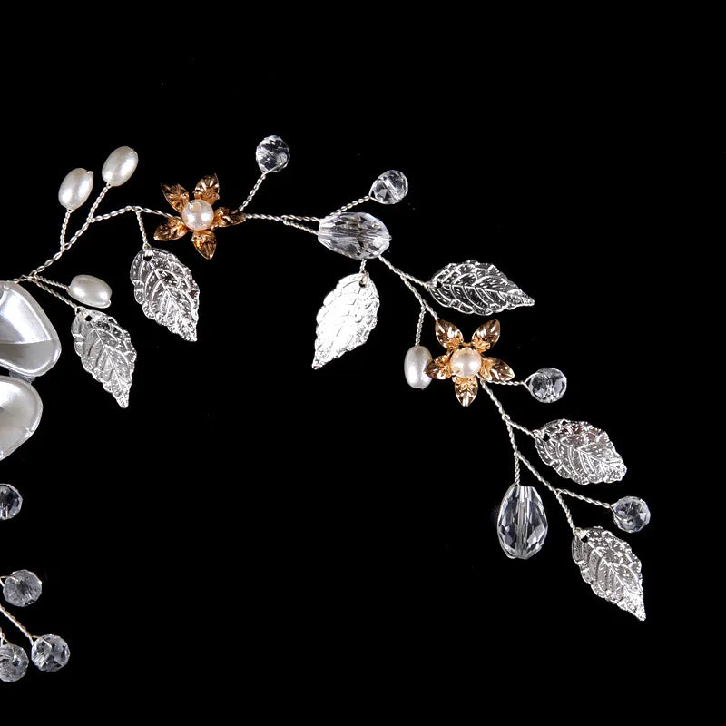 Close-up of the silver vine end with small gold flowers, pearls, clear crystal drops and silver leaves