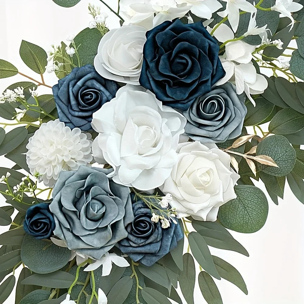 Close-up of navy, dusty blue and white artificial roses with a white dahlia and eucalyptus leaves