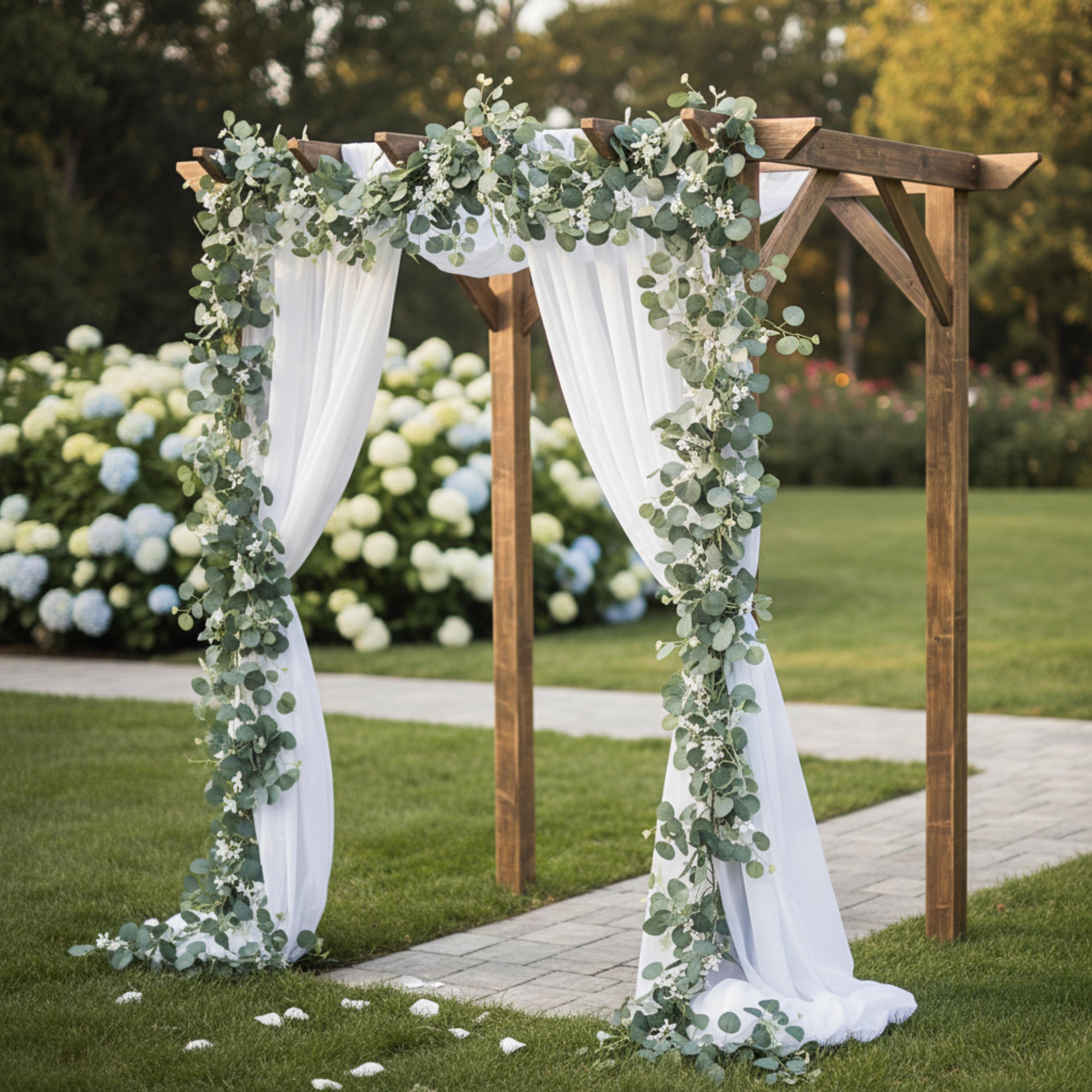 Wedding arch decorated with faux eucalyptus garland and white flowers