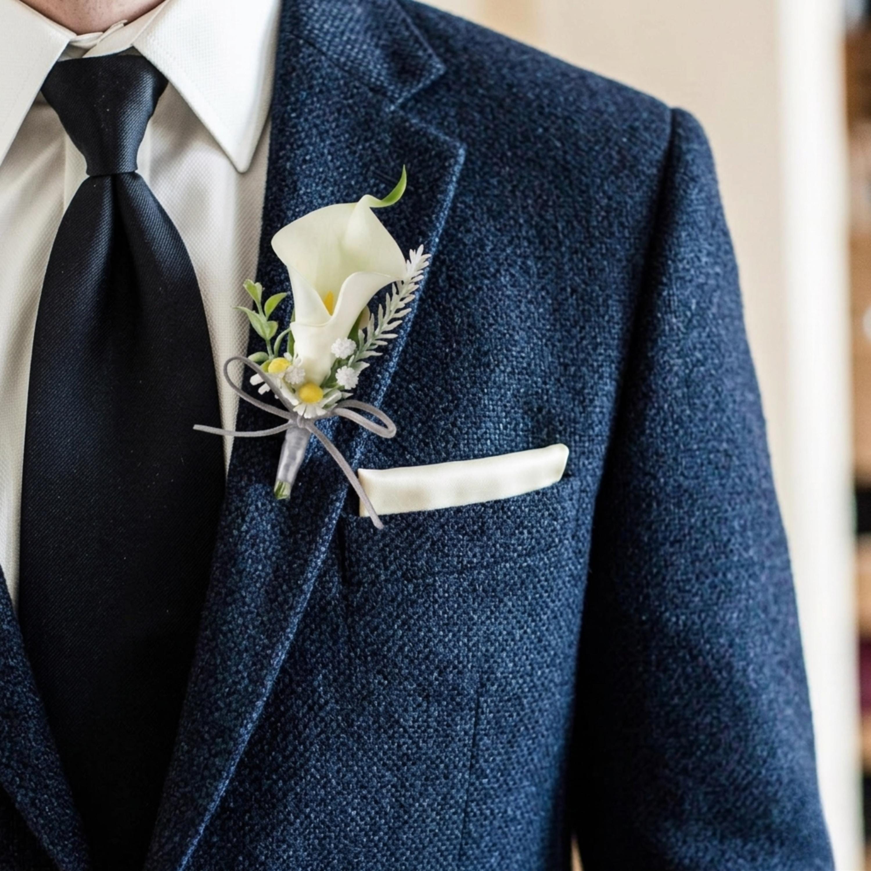 White boutonniere on navy suit for groom or groomsman wedding flowers