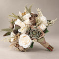 Artificial bridal bouquet with ivory roses, sage green roses, taupe rosebuds and feathery cream fillers on a gray backdrop